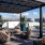pergola covered sitting area with table and chairs on rooftop